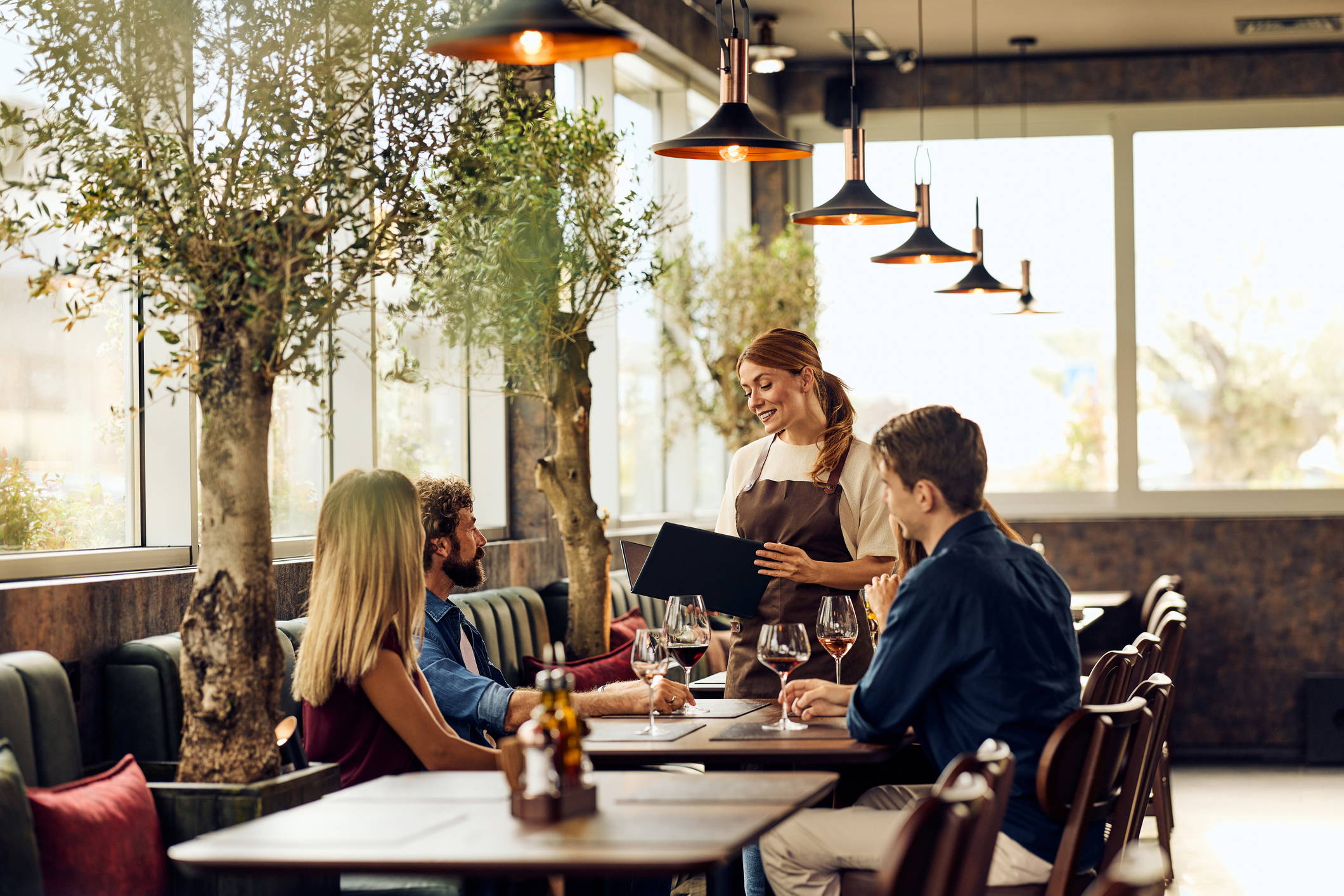 Group Dining Experience at a Modern Restaurant with Engaged Conversations and Service Mini dental implants at London Road Dental Surgery